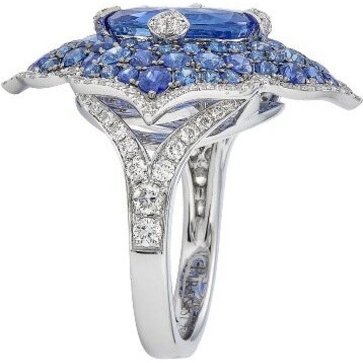 This Pacha Ring in Blue Sapphire from Piranesi is the ultimate statement piece for any jewelry collection. The breathtaking cushion blue sapphire at the center weighs 5.31 carats and is surrounded by 2.87 carats of round blue sapphires. The added touch of a white round diamond weighing 0.80 carats only adds to the ring's brilliance. Set in 18K white gold, this ring will surely make heads turn with its stunning design and impeccable craftsmanship. Whether you're buying it for yourself or as a gif Luxury Gia Certified Cushion Cut Sapphire Ring, Luxury Cushion Cut Sapphire Diamond Ring, Luxury Sapphire Birthstone Ring, Luxury Sapphire Cluster Ring, Luxury Cushion Cut White Gold Sapphire Ring, Luxury Platinum Sapphire Ring With Cushion Cut, Luxury Cushion Cut Sapphire Ring With Center Stone, Luxury White Gold Cushion Cut Sapphire Ring, Luxury Sapphire Ring With Cushion Cut In Platinum