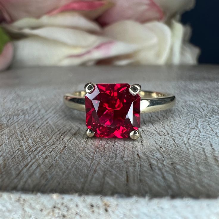 "This ring is a radiant cut lab created ruby with open u setting solitaire, 14k yellow gold #6217 This ring can be made with many different stone colors Message us for pricing on different color/type stones **Ruby is birthstone of July** -Approximate total carat weight: 2.10ctw diamond equivalent -Center Stone Size: approx. 1.75 ct diamond equivalent -Center Stone Shape: radiant 7x7mm -Gem Type: lab created ruby -Stone Clarity: AAA -Stone Color: red -Moh's Scale: 9 hardness -Metal Type and Purit Red Cushion Cut Ring With Accent Stones, Radiant Cut Red Ruby Ring For Wedding, Ruby Ring With Brilliant Cushion Cut For Anniversary, Classic Birthstone Ring With Radiant Cut Center Stone, Classic Solitaire Ruby Ring With Lab-created Ruby, Ruby Ring With Cushion Cut For Anniversary, Classic Red Solitaire Ruby Ring, Lab-created Ruby Ring With Prong Setting For Proposal, Cushion Cut Lab-created Ruby Ring In Red