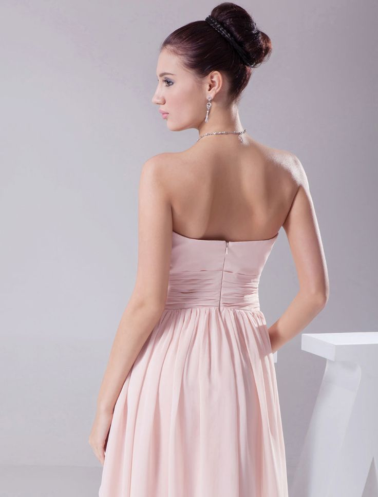 the back of a woman's dress in pink