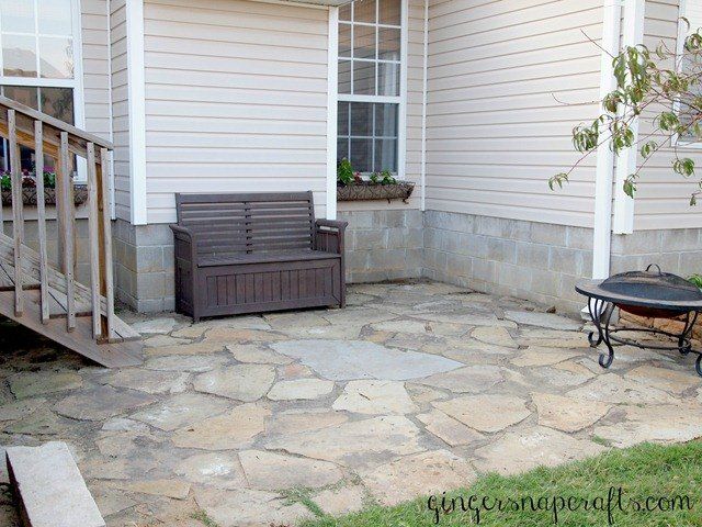 a bench sitting on top of a stone patio