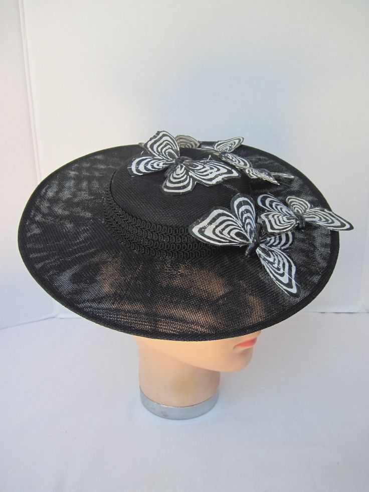 "* This black Sinamay hat form has a 12\" diameter and has a subtle and sophisticated animal print enhanced with the spectator feathered butterflies. The band is a woven braid and coordinates with the subdued hat print. * The hat has been designed to sit on either side of the head with an acrylic headband. * Upon ordering this is the exact hat you will receive. * Perfect to wear to any Special Event or Celebration, Ladies Luncheon, Derby Parties, Weddings, Wedding or Baby Shower, Anniversary, Fa Acrylic Headband, Hat Form, Sinamay Hat, Ladies Luncheon, Sinamay Hats, Hat Print, Derby Party, Winter Photo, White Feathers