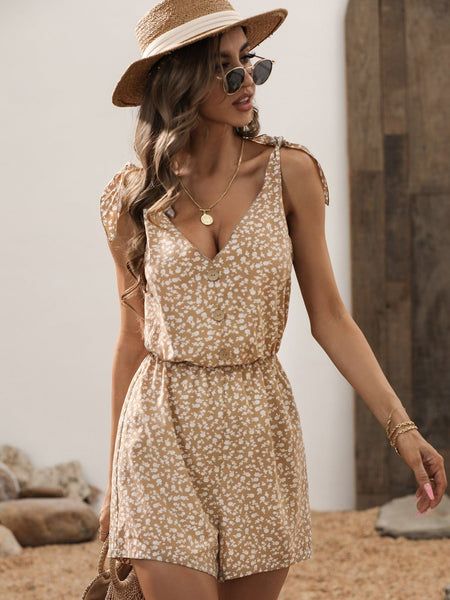 The EMES SHOP romper is detailed with a cute tie shoulder design. Features a v neck line. ditsy floral print. button front. and regular fit. Pair it with a sun hat and sunnies for a fun summer look.MATERIALS: 100% Blended cottonMEASUREMENTS: Product length is 31"- 34" in 4-6-Small | Waist: 25?26.5?in | Chest: 33?34.5?in | Hips: 35?36.5?in 6-8-Medium | Waist: 26.5?28?in | Chest: 34.5?36?in | Hips: 36.5?38?in 8-10-Large | Waist: 28?29.5?in | Chest: 36?37.5?in | Hips: 38?39.5?in 10-12-X-Large | ... Spring Vacation Jumpsuits And Rompers With Adjustable Straps, Casual V-neck Sundress For Summer Outings, Spring Day Out Jumpsuits And Rompers With Tie Straps, Trendy Summer V-neck Jumpsuits And Rompers, Summer Jumpsuits And Rompers With Adjustable Straps, Trendy V-neck Jumpsuits And Rompers For Summer, Casual Summer Jumpsuits And Rompers With Tie Straps, Spring Vacation Jumpsuits And Rompers With Tie Straps, Trendy Summer Sundress With Adjustable Straps