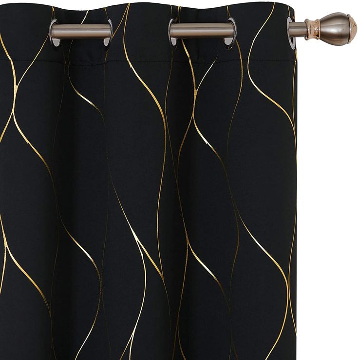 a black curtain with gold lines on it and a metal rod attached to the side