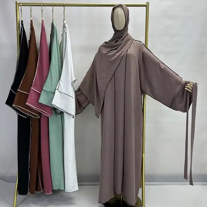 The Panda Piping Three Piece Abaya Set is a one of a kind 3 piece abaya set inspired by streetwear. This set is made of premium jazz crepe fabric, and includes a short sleeve maxi dress, a long sleeve open abaya kimono with complimentary piping design, and a matching belt and hijab! Available in 6 colors and ready for you and a day out. Front Open Abaya, Traditional Women, Piping Design, Abaya Kimono, Open Abaya, Short Sleeve Maxi Dress, Rosé Brown, Business Tops, Short Sleeve Maxi Dresses