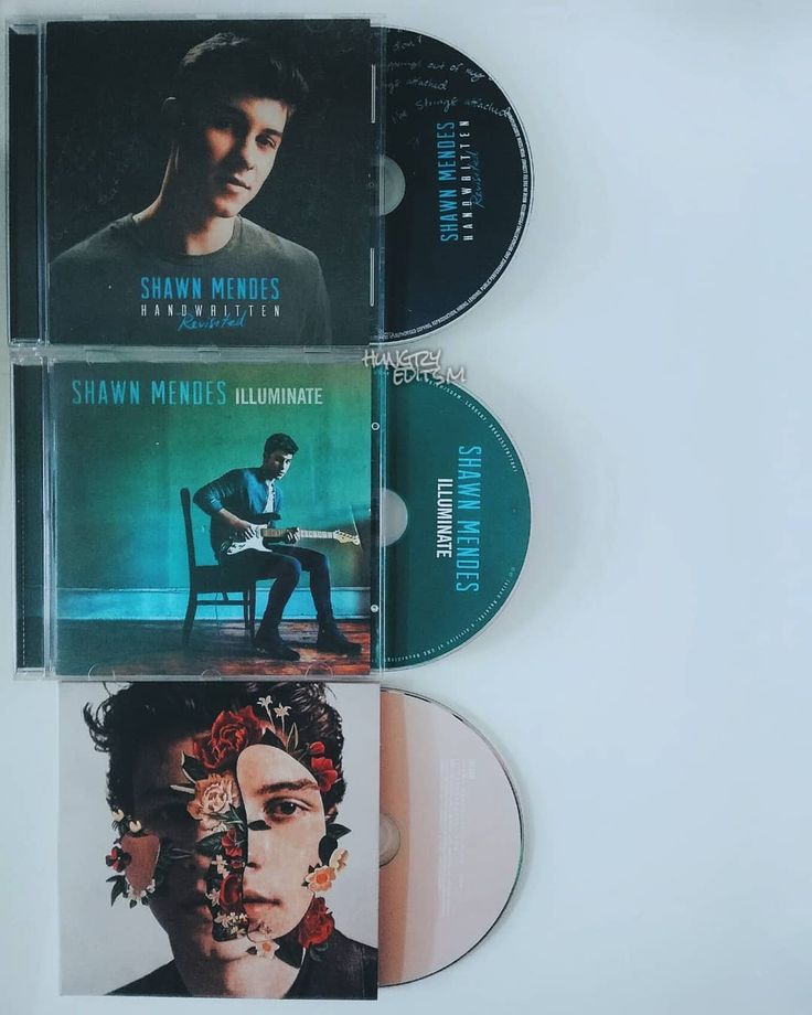 three cds sitting next to each other on top of a white surface with an image of a man