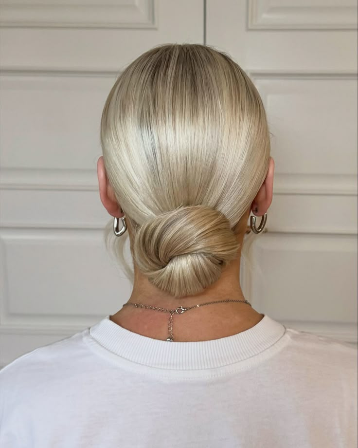 From trial to wedding day. A beautiful sleek and minimalistic modern low bun. #weddinghair #belfasthair #bridalhair #clandeboyewedding #lowbun #sleekhair #modernbride #sleekbun #northernirelandwedding #weddinghairstylist #belfastbride #belfastweddinghair #hairtrends #summerhair #weddinghairideas #weddinghairstyles #upstyle Low Slick Bun Wedding, Smooth Low Bun, Sleek Bride Hair, Low Bun Wedding Hair Blonde, Wedding Hair Sleek Bun, Slick Back Bun Wedding Hair, Effortless Low Bun, Sleek Bridal Bun, Slick Back Buns