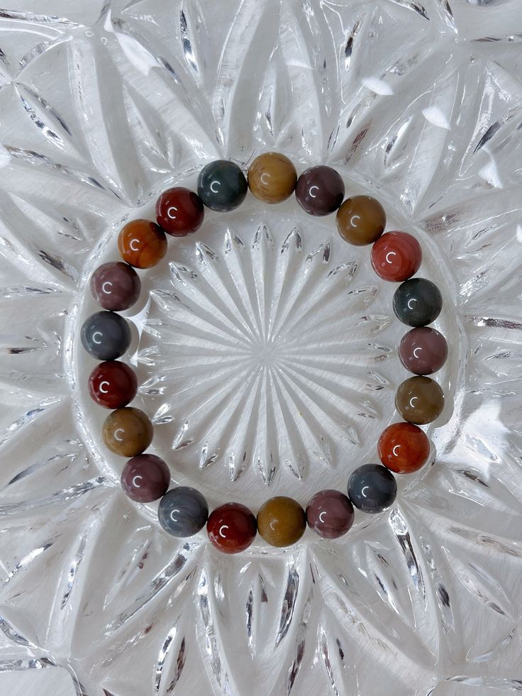 "You will receive one stunning, high quality Alashan Agate bracelet. A natural mix of warm, rainbow colours. This beaded crystal bracelet is made \"one size\", and stretches to fit. It measures roughly 6.75 cm in diameter, and the beads measure 9mm. * * * * * ABOUT ALASHAN AGATE: Alashan agate is a type of agate that is known for its unique patterns and colors. It is a semi-precious gemstone that is found in the Alxa League of Inner Mongolia, China.  Yanyuan agate, named after Yanyuan County in Sichuan, China, is a variety of banded chalcedony, a mineral of the quartz family. They are known for their diverse and striking colors, usually forming in volcanic rocks or limestones. ❀ * * * * * Follow me on Instagram: instagram.com/ambers.expressions" Rainbow Crystal Bracelet With Natural Stone Round Beads, Rainbow Crystal Bracelet With Natural Stones, Rainbow Crystal Bracelet With Natural Stones And Round Beads, Multicolor Crystal Bracelet With Round Natural Stones, Earthy Multicolor Gemstone Beaded Bracelets, Earthy Multicolor Gemstone Beads Bracelet, Earthy Multicolor Round Beads Bracelets, Earthy Multicolor Beaded Bracelets With Natural Stones, Earthy Multicolor Beaded Bracelet With Natural Stones