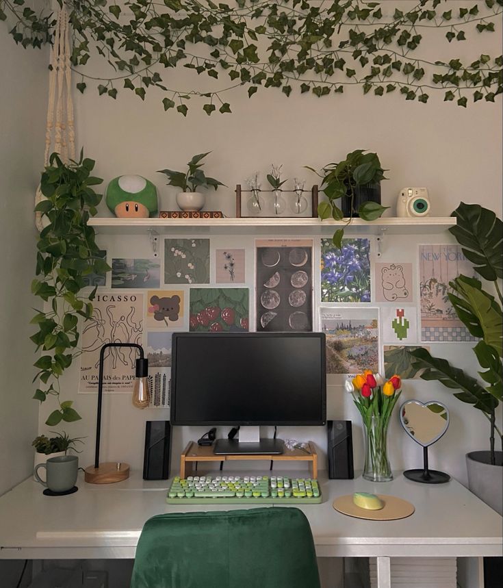 a desk with a computer, keyboard and plants on it