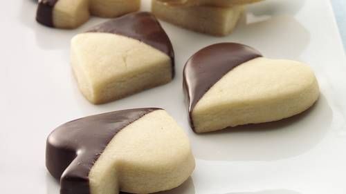 chocolate dipped cookies are arranged on a white plate