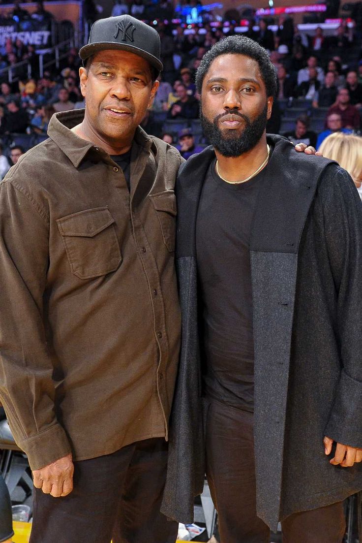 two men standing next to each other at a basketball game