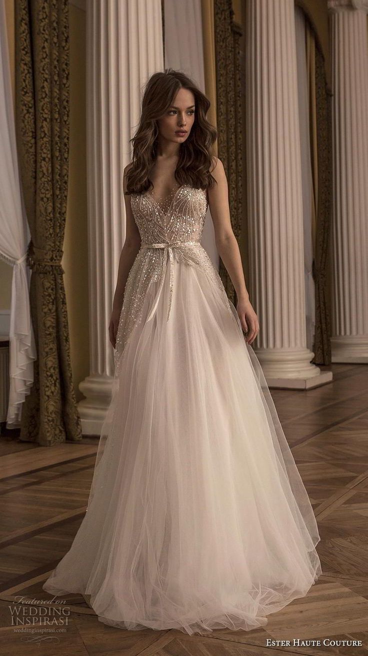 a woman in a wedding dress standing on the floor