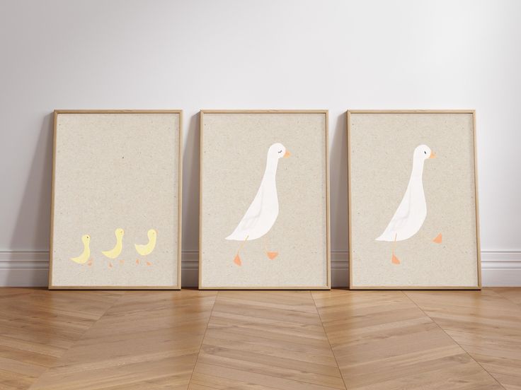 three framed pictures with ducks on them in front of a white wall and wooden floor