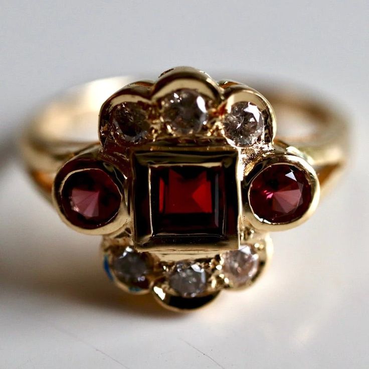 St. Nicholas 14k Gold Garnet and Diamond Ring : Museum of Jewelry Classic Cluster Ruby Ring, Classic Ruby Ring With Rose Cut Diamond Cluster, Cluster Ruby Ring With Diamonds, Classic Red Ruby Cluster Ring, Classic Red Cluster Ruby Ring, Classic Red Cluster Diamond Ring, Red Diamond Cluster Ring With Halo Setting, Classic Formal Burgundy Rings, Elegant Red Ruby Cluster Ring