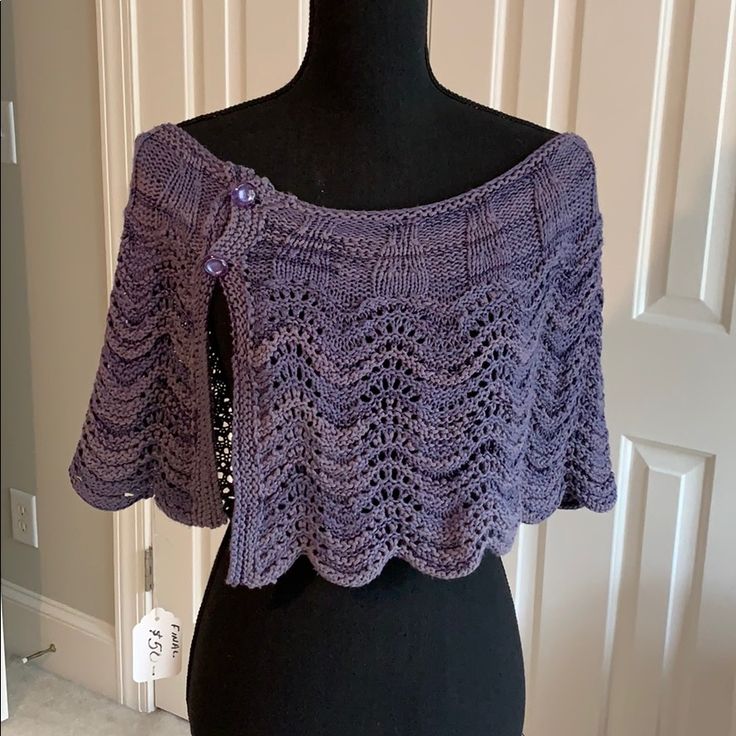 a purple crocheted top on a mannequin