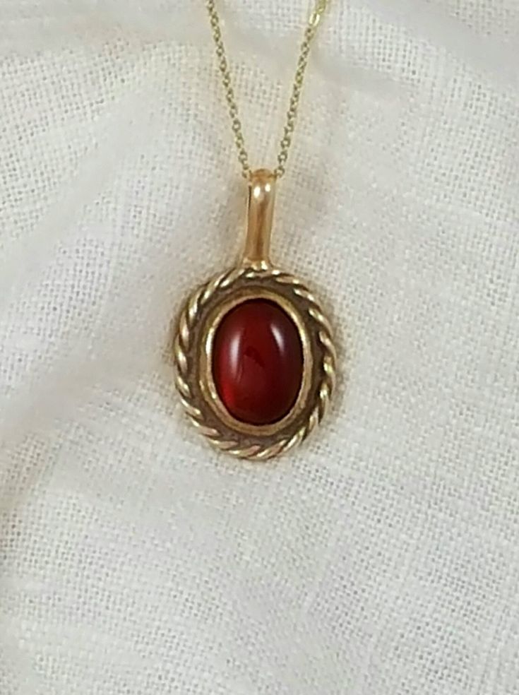 Hand-Crafted Ancient Bronze Pendant with a genuine 10x12 mm Carnelian stone.    Other stone options are available Approx Dimensions:  Length:  1 inch Width: 3/4 inch Total Length with loop: 1 1/4 inches Designed and Handcrafted by Randy from start to finish. Comes with a black adjustable cotton cord. Stones are natural and may vary in color.  Our pieces are made of solid jewelry grade ancient bronze and are not coated with any type of sealant that can chip off.   To keep your piece looking bright and shinny simply use a jewelry polishing cloth. Vintage Carnelian Jewelry With Polished Finish, Formal Carnelian Oval Cabochon Jewelry, Classic Carnelian Yellow Gold Jewelry, Vintage Polished Carnelian Jewelry, Classic Yellow Gold Carnelian Jewelry, Formal Oval Cabochon Carnelian Jewelry, Formal Carnelian Cabochon Jewelry, Antique Oval Cabochon Gemstone Necklaces, Antique Oval Carnelian Jewelry