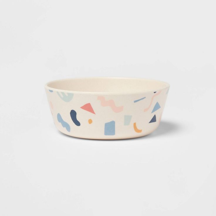 a white bowl with colorful shapes on it