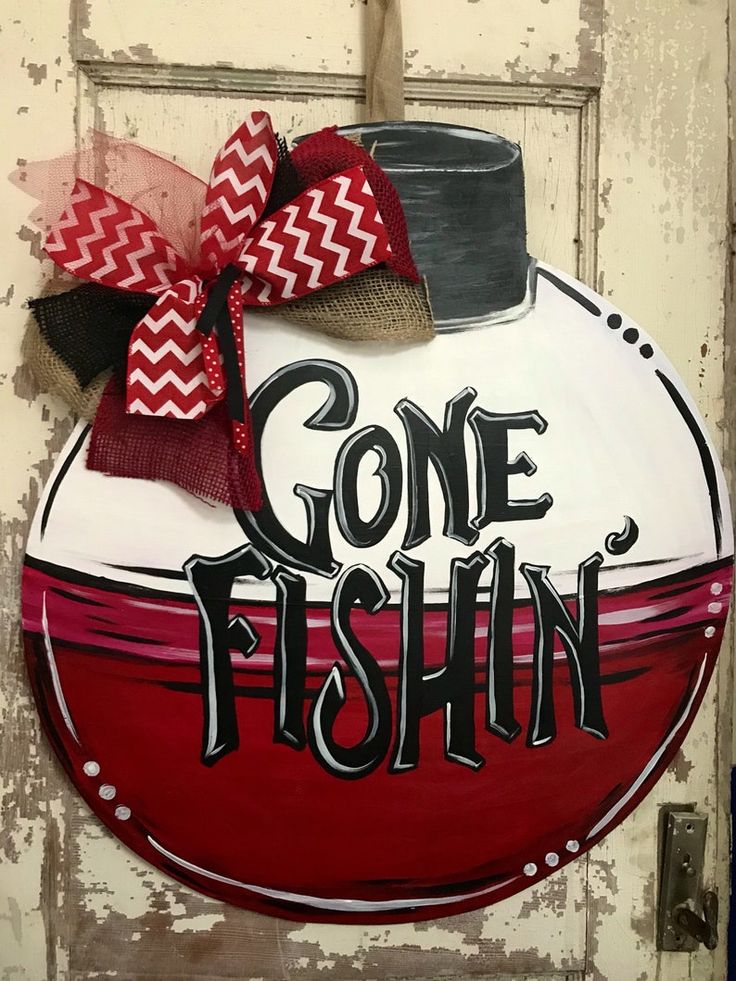 a red and white sign that says gone fishin with a hat on it's head