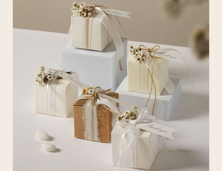 three gift boxes with ribbons tied around them