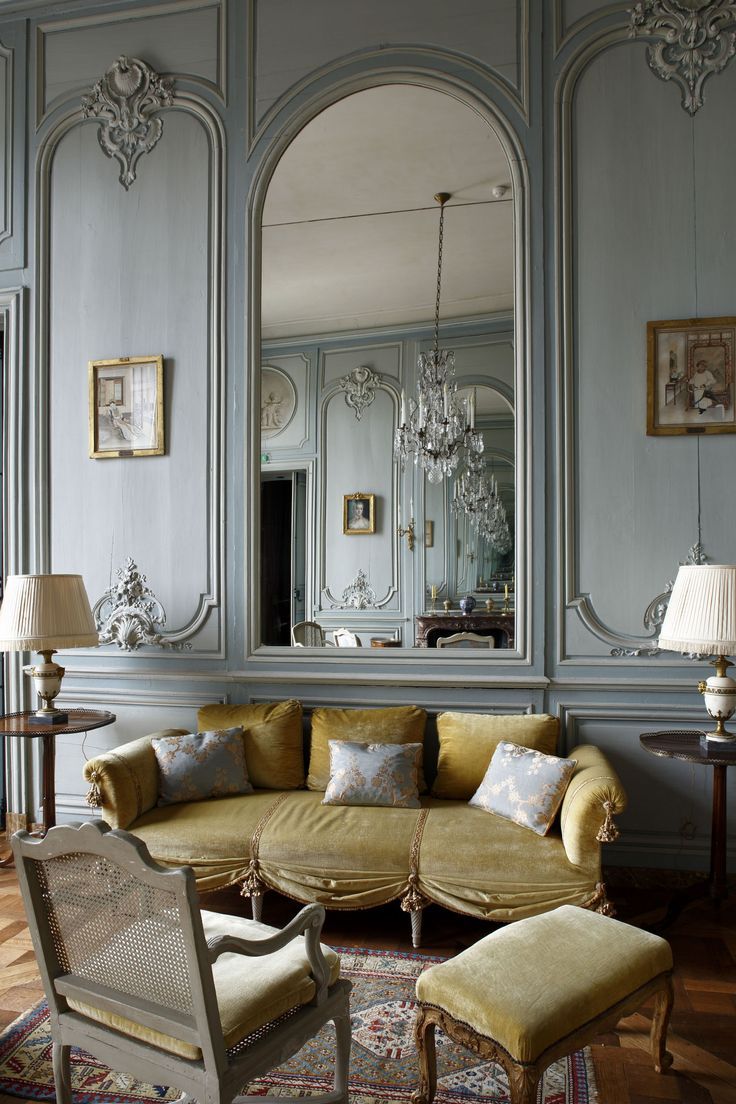 a living room filled with furniture and mirrors