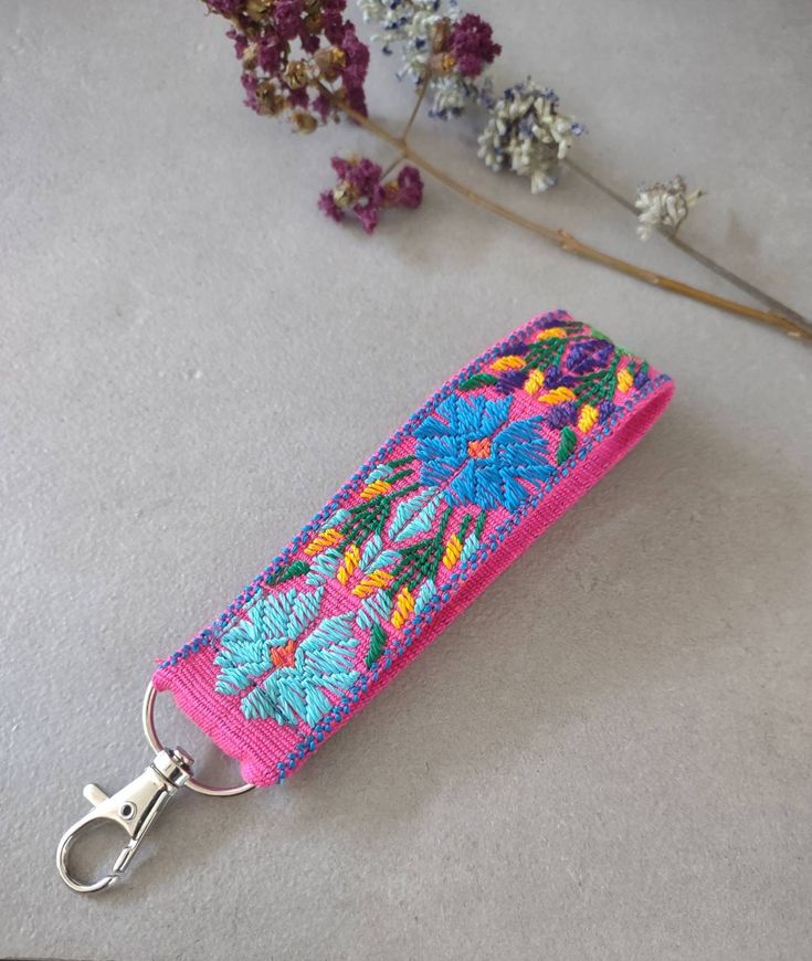 These unique woven key wristlet is intricate and detailed with a beautiful floral pattern. Our floral keychains are designed for function and beauty. The wristlet fob is made of premium hand dyed threads, feels great to wear - sturdy but soft. It is made with quality material, and handmade by a simple hip strap loom, excellent texture. Take the wristlet keychain with you make it easy to attach your keys, making them easy to find in your backpack or purse. They make wonderful gifts for teachers, Cute Wristlets Keychains, Cute Wristlet Keychains, Handmade Pink Bracelet For Everyday Use, Handmade Rectangular Wristlet For Gift, Handmade Pink Bracelet For Everyday, Rectangular Keychain With Wrist Strap Gift, Rectangular Wristlet With Key Clip As Gift, Cute Key Wristlet, Pink Bohemian Wristlet For Gift