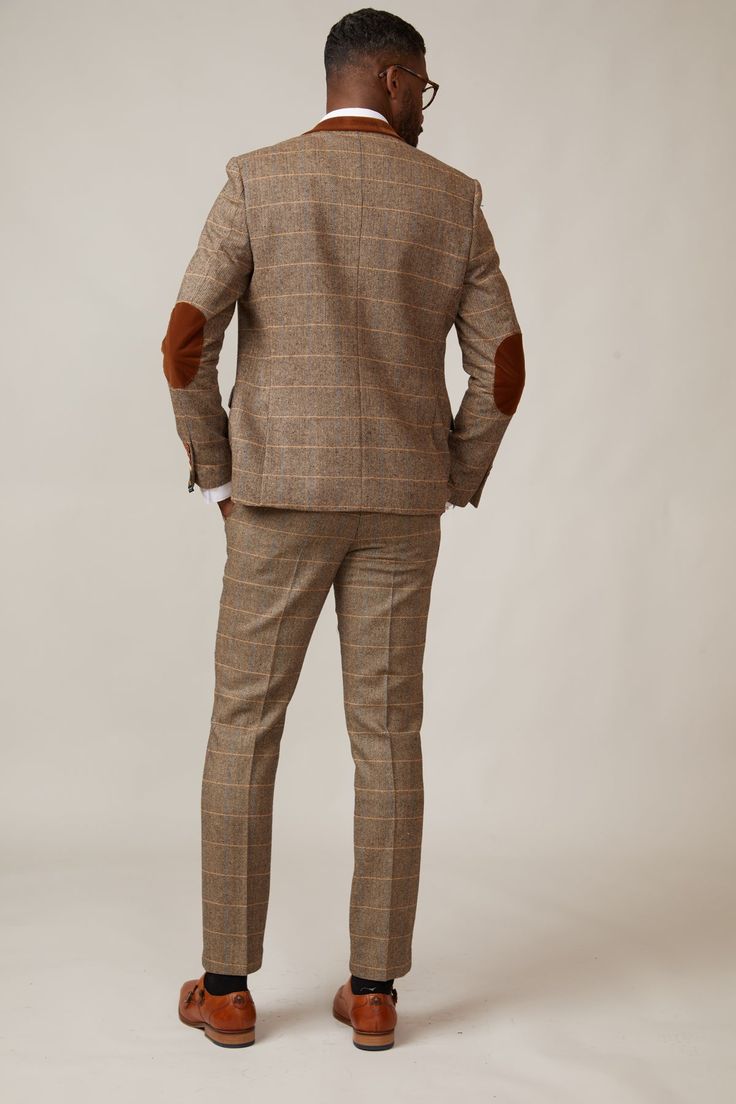 Inspired by old age country wear, the DX7 suit remains an ever so popular style, reminiscent of the 18th century. It is ideal for Autumn/Winter with its earthy colour palette and heavy fabric. A touch of modernism is added with a velvet contrast collar, elbow pads and pocket trims, nudging it back into the 21st century. Perfect for a rustic countryside wedding. Mix-and-match the waistcoat to differentiate from the groomsmen and match your accessories with the bridesmaid dresses. Looking for a pl Tailored Beige Tweed Jacket With Suit Collar, Tailored Wool Suits For Fall, Brown Double Breasted Suit For Business In Fall, Brown Tailored Suits With Pockets, Tailored Brown Suits With Pockets, Winter Tweed Three-piece Suit For Work, Classic Brown Double Breasted Suit For Winter, Winter Brown Double Breasted Suit For Business, Winter Tweed Three-piece Suit For Business