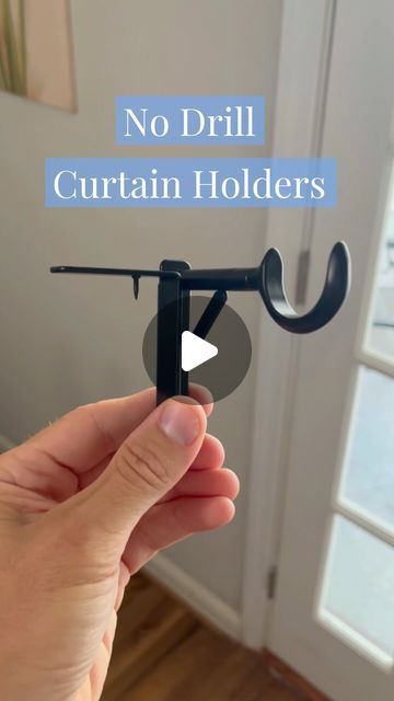 a hand holding an umbrella hook with the words no drill curtain holders