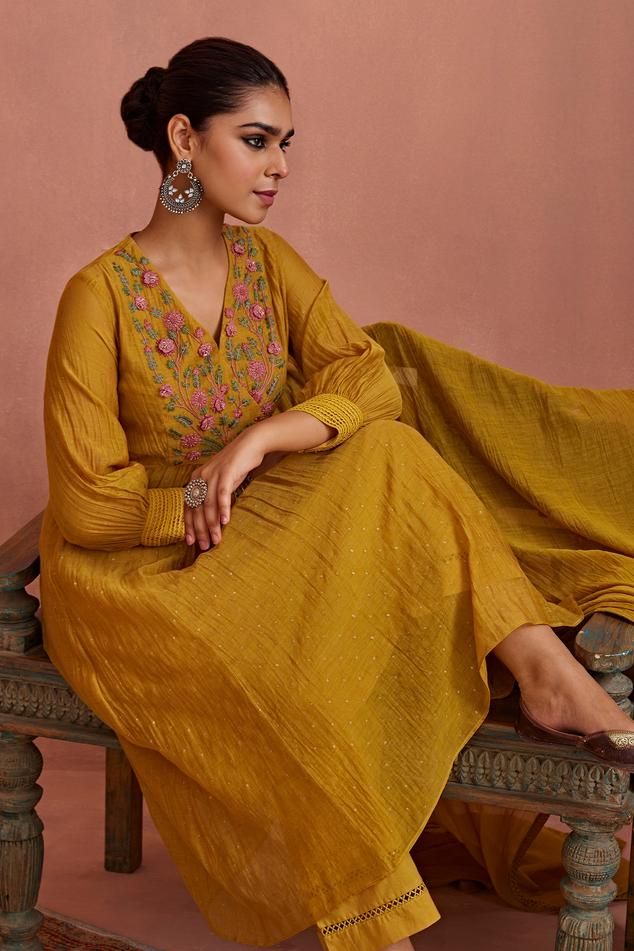 Yellow chanderi kurta with 3D floral and thread hand embroidered yoke. Comes with cotton pant, a dupatta and a slip.
Components: 4
Pattern: Hand embroidered
Type Of Work: Floral, Thread
Neckline: V Neck
Sleeve Type: Puffed Sleeves
Fabric: Chanderi, Pant: Cotton
Color: Yellow
Other Details: 
Length:
Kurta: 46 inches
Pant: 38 inches
Occasion: Mehendi and Haldi - Aza Fashions Floral Embroidered Chanderi Churidar For Navratri, Floral Embroidery Chanderi Churidar For Navratri, Cotton Silk Sets With Floral Embroidery For Transitional Season, Transitional Cotton Silk Sets With Floral Embroidery, Semi-stitched Cotton Silk Churidar With Floral Embroidery, Chanderi Sharara With Floral Embroidery For Eid, Festive Chanderi Sharara With Floral Embroidery, Traditional Cotton Silk Churidar With Floral Embroidery, Floral Embroidered Chanderi Sharara For Eid