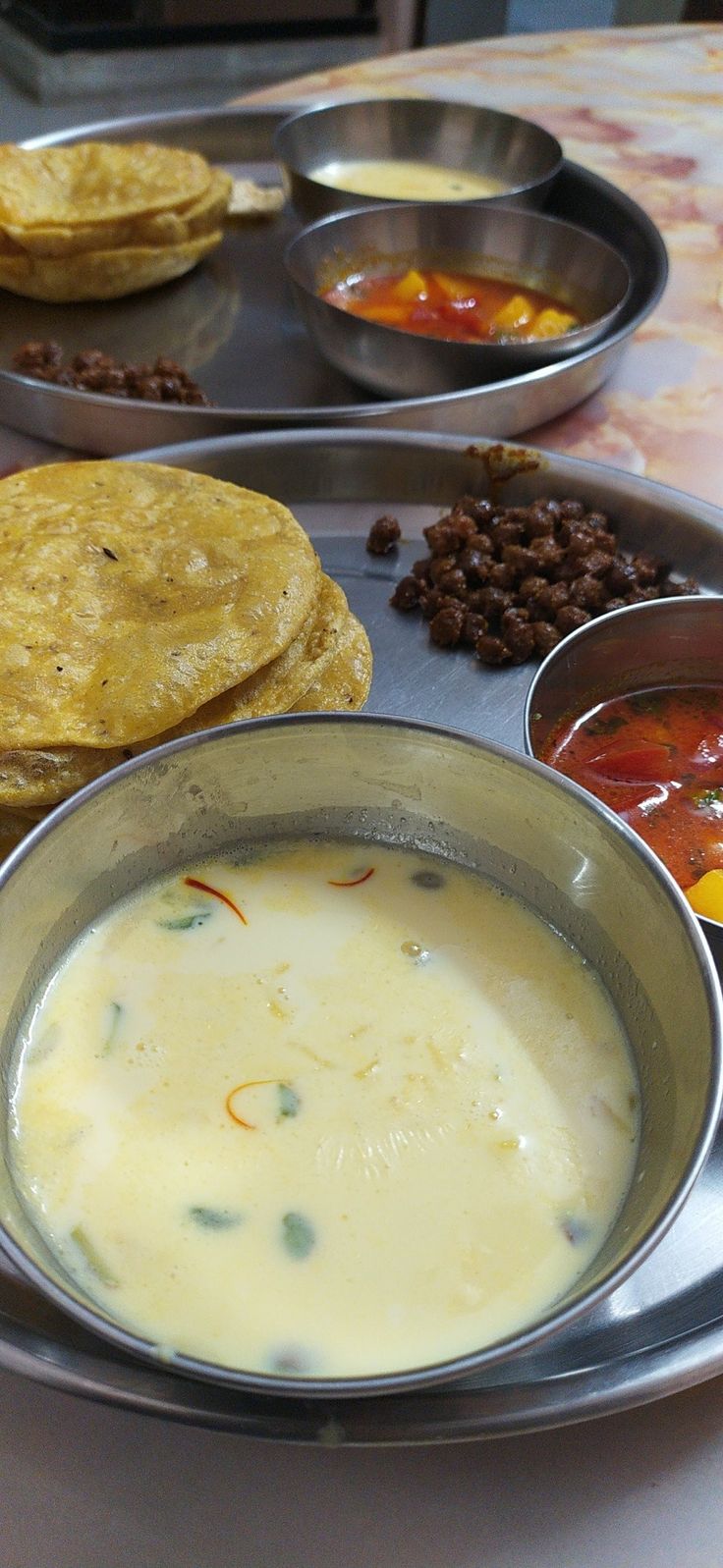 there are many different types of food on the table, including pita bread and soup