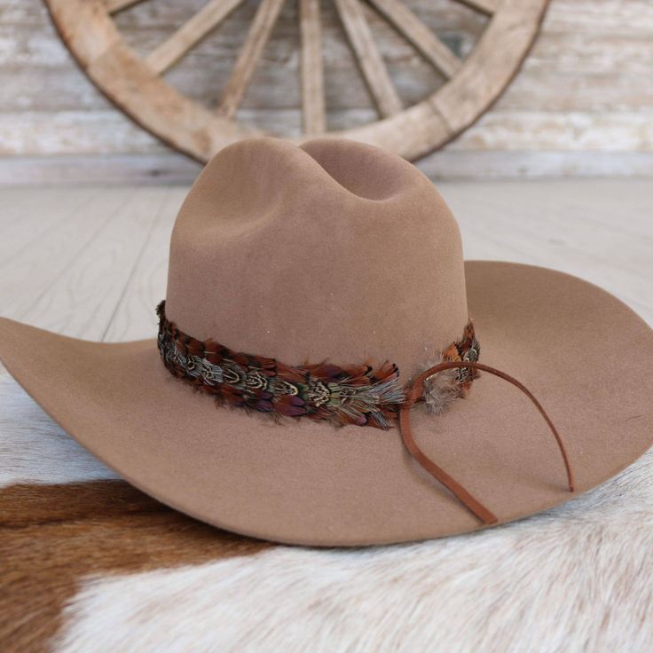 The Brazons Western Feather Hat Band, with its 3 cm width and approximately 58 cm length (excluding leather ties), offers a blend of rugged style and sophisticated detailing. Crafted to fit most, this band is easily adjustable with leather ties, ensuring a secure fit and a touch of personalized flair. Perfect for those who appreciate the subtle elegance of western-inspired accessories, this feather-adorned hat band adds a distinctive edge to any hat. Adjustable Country Hat Bands For Fall, Western Leather Hat Bands For Festival, Adjustable Leather Felt Hat For Western-themed Events, Rustic Leather Hat Bands For Rodeo, Western Leather Hat Band With Sweatband, Adjustable Hat Bands For Country Events In Fall, Adjustable Fedora For Country Events, Adjustable Country Style Fedora Felt Hat, Rustic Adjustable Felt Hat For Festival