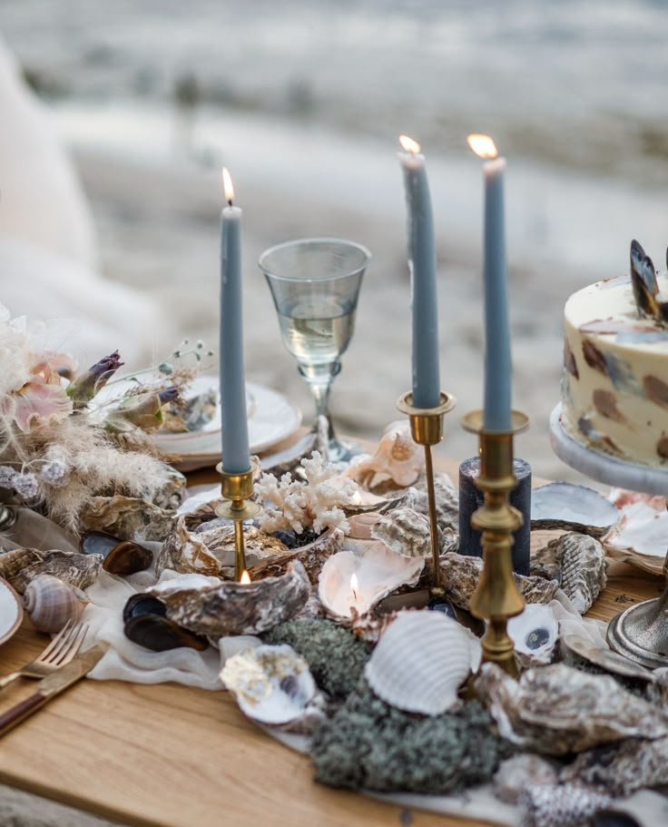 a table with candles and seashells on it