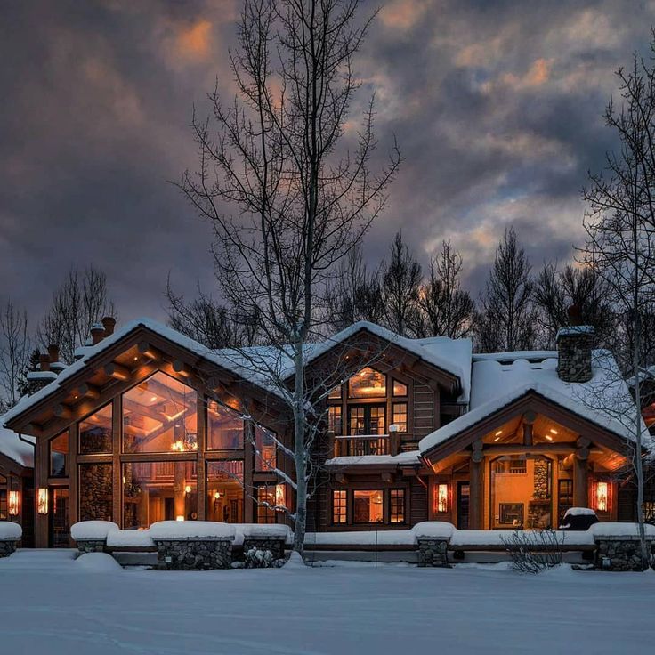 a large log home in the middle of winter