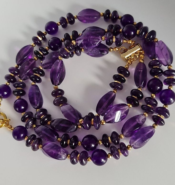 Handmade jewelry set of natural Amethyst.  Necklace made of different shape Amethyst beads with gold Hematite accents. Length 60cm. Toggle. Layered bracelet of natural Amethyst. Magnetic clasp. For16-16.5cm wrist. Suitable for air signs of the zodiac, especially Aquarius and Aries.  The set comes in a gift box ready for gifting. You might also like https://www.etsy.com/uk/shop/LoveIuliia?ref=seller-platform-mcnav§ion_id=38541683 https://www.etsy.com/uk/shop/LoveIuliia?ref=l2-about-shopname§ion_i Elegant Amethyst Rondelle Jewelry, Rondelle Gemstone Necklace Gift, Elegant Amethyst Rondelle Necklaces, Gemstone Rondelle Necklaces For Gifts, Elegant Amethyst Rondelle Necklace, Gemstone Rondelle Necklace For Gift, Spiritual Rondelle Crystal Necklace As Gift, Spiritual Rondelle Crystal Necklace For Gift, Hand-strung Rondelle Necklaces For Gifts