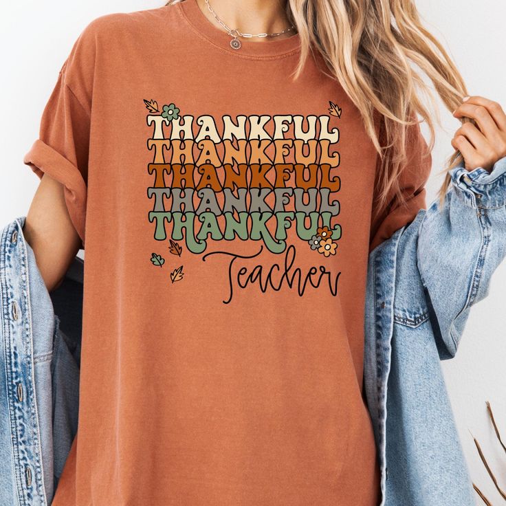 Stay cozy and stylish this fall season with our  Fall Teacher shirt Thanksgiving tshirt,Thanksgiving Shirt Pumpkin tshirt,Halloween festivities this Fall Sweatshirt features a cute  design that will make you stand out. Show your gratitude with our thankful shirt while staying warm in this soft and comfortable Thanksgiving sweatshirt. Ideal as a Thanksgiving gift for family or friends, this fall shirt is a must-have addition to your autumn wardrobe. Order now and embrace the spirit of the season Casual Fall Tops With Funny Text, Casual Thanksgiving T-shirt With Letter Print, Cute Fall T-shirt With Relaxed Fit, Fall Graphic Tee With Funny Text, Funny Print Long Sleeve T-shirt For Fall, Orange Graphic Print T-shirt For Fall, Thanksgiving Cotton T-shirt With Letter Print, Casual Thanksgiving T-shirt With Graphic Print, Casual Thanksgiving Graphic T-shirt