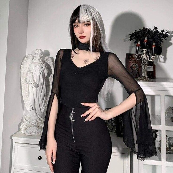 When Darkness Comes Top. This sheer mesh top has flared bell sleeves and a collar neckline with a back closure and a front cutout. Product Details Black Polyester, Spandex Size Guide Size Chest Waist Sleeve Length S 77 64 70 M 81 69 71 L 85 73 72 Unit: cm NOTE: 1. Please strictly follow the size chart to select the size. Do not select directly according to your habits. 2. The size may have 2-3cm differs due to manual measurement. Please note when you measure How to Measure To choose the correct Gothic Mesh Top With Mesh Sleeves For Night Out, Gothic Fitted Top With Sheer Sleeves, Fitted Gothic Mesh Top, Fitted Gothic Top With Sheer Sleeves, Black Gothic Top With Sheer Sleeves, Black Sheer Mesh Top Gothic Style, Gothic Tops With Sheer Sleeves For Night Out, Black Gothic Tops With Mesh Sleeves, Black Tops For Spring Cosplay