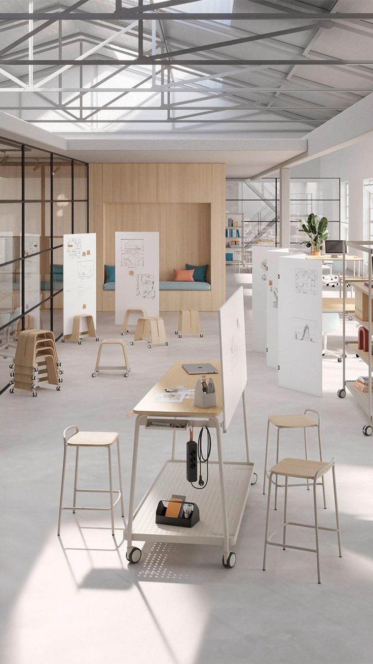 an empty room with several tables and stools on the floor in front of them