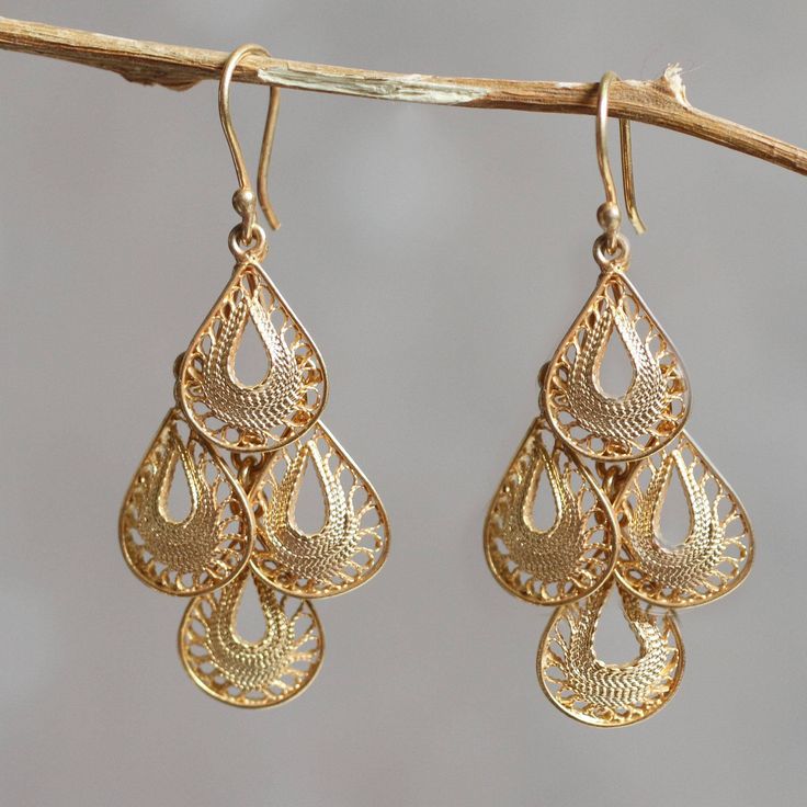 Four lacy raindrops fall in a dancing cascade bathed in 21k gold. Intricately crafted of sterling silver strands the filigree earrings are the handiwork of Giuliana Valz-Gen. .925 Sterling silver