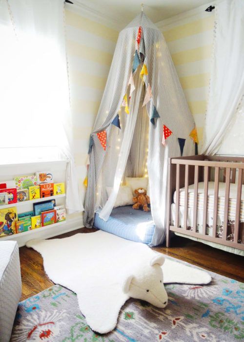 a child's room with a bed, crib and rugs on the floor