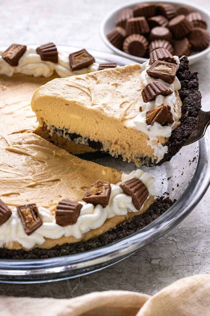 there is a pie with chocolate and cream toppings on the top, ready to be eaten