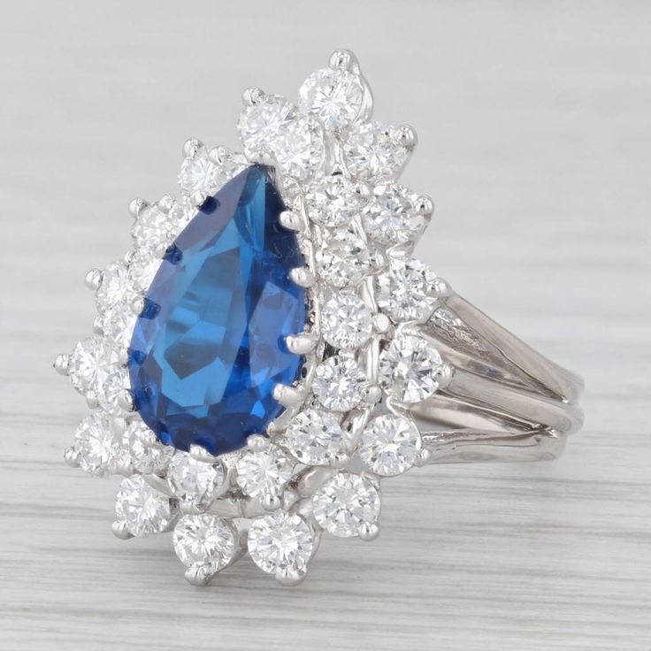 Gemstone Information: - Lab Grown Spinel - Total Carats - 2.4ct Cut - Pear Color - Blue - Natural Diamonds - Total Carats - 1.64ctw Cut - Round Brilliant Color - F - G Clarity - SI1-I1 Metal: 14K White Gold Weight: 8.2 Grams  Stamps: 14K Face Height: 23.2 mm  Rise Above Finger: 12.6 mm Band / Shank Width: 4 mm This ring is a size 5.75, but it can be resized down 1 sizes for a $25 fee or up 2 sizes for a $60 fee. Please type in "Ring Sizing Fee" in the search bar if you wish to have this ring sized. If you would like your ring resized, please select the appropriate fee from the listing below in order to pay the sizing fee: https://www.etsy.com/listing/781388346/ring-sizing-service-fee Each piece is thoroughly examined and refinished as needed by our professional jewelers, graded by our in-h Formal Pear-shaped Sapphire Ring With Vvs Clarity, Formal Vvs Clarity Pear-shaped Sapphire Ring, Gia Certified Teardrop Diamond Ring For Formal Occasions, Luxury Pear-shaped Sapphire Ring With Prong Setting, Formal Gia Certified Teardrop Diamond Ring, Pear-shaped Sapphire Ring With Brilliant Cut Diamond, Elegant Gia Certified Teardrop Diamond Ring, Formal Gia Certified Pear-shaped Rings, Formal Pear-shaped Sapphire Ring With Brilliant Cut