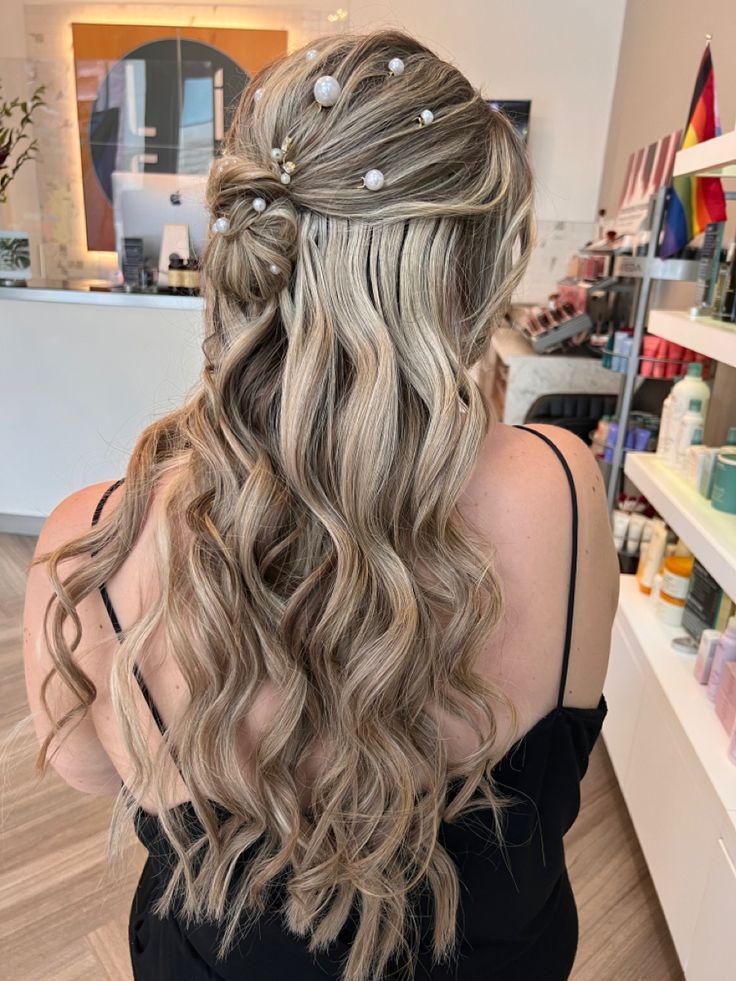 a woman with long, wavy hair in a store