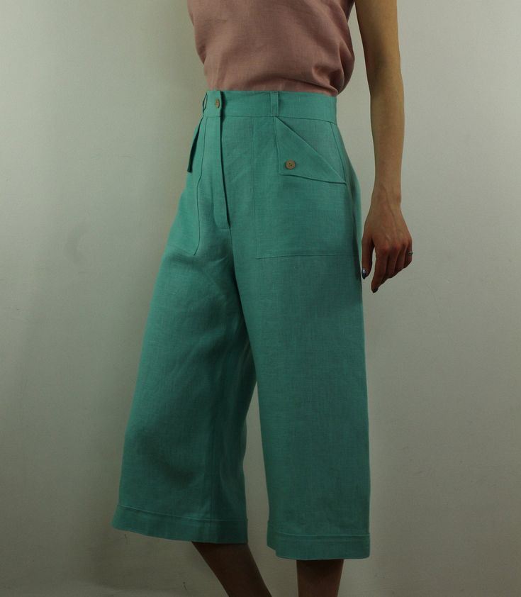 "Women linen cropped pants with 2 pockets in turquoise color, perfect for casual wear and suitable for any occasion in any season Details: - 100% natural linen produced in Europe ; - medium weight (180 gram per square meter); - color: turquoise, could be any from our colors catalogue (color samples at the photo); Made to order, approximately a few days, If you have any questions please message me and I will be glad to answer. Size guide : Size XS Bust: fits bust around 33\"-34\"/ 84-88 cm Waist: Green Cropped Leg Bottoms, Summer Green Wide Leg Pants With Side Pockets, Linen Capri Pants With Pockets, Green Linen Bottoms With Side Pockets, Green Wide Leg Capris For Summer, Green Straight Leg Capris With Pockets, Casual Turquoise Wide Leg Bottoms, Green Summer Capris, Green Ankle-length Capris For Summer