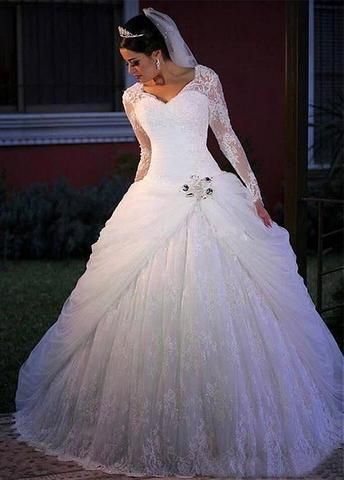 a woman in a white wedding dress standing outside