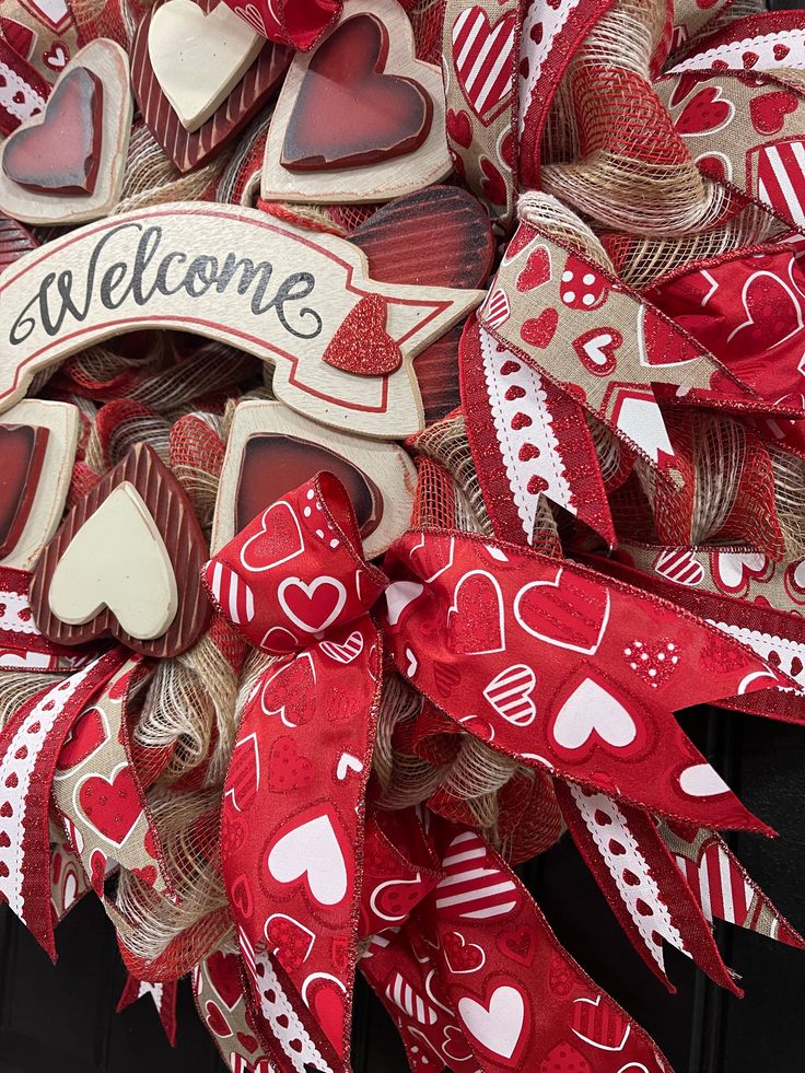 a welcome wreath with red and white hearts