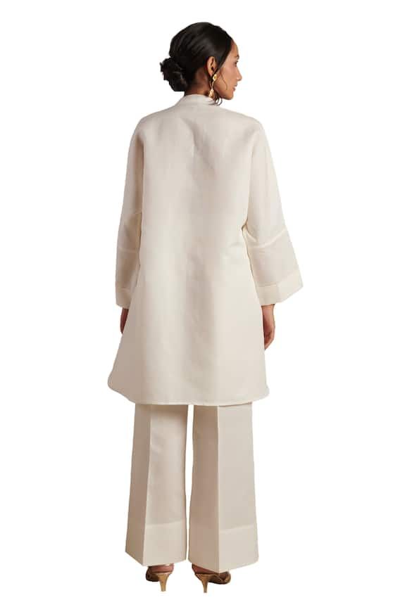 Off-white tunic with spread collared neckline. Paired with straight cut flared pant. - Aza Fashions White Blouse With Concealed Placket For Spring, Elegant Linen Tunic For Workwear, Elegant Linen Daywear Sets, Elegant Linen Sets For Daywear, Elegant Linen Kurta For Spring, Elegant Stand Collar Kurta For Spring, White Tunic, Straight Cut, Pure Linen