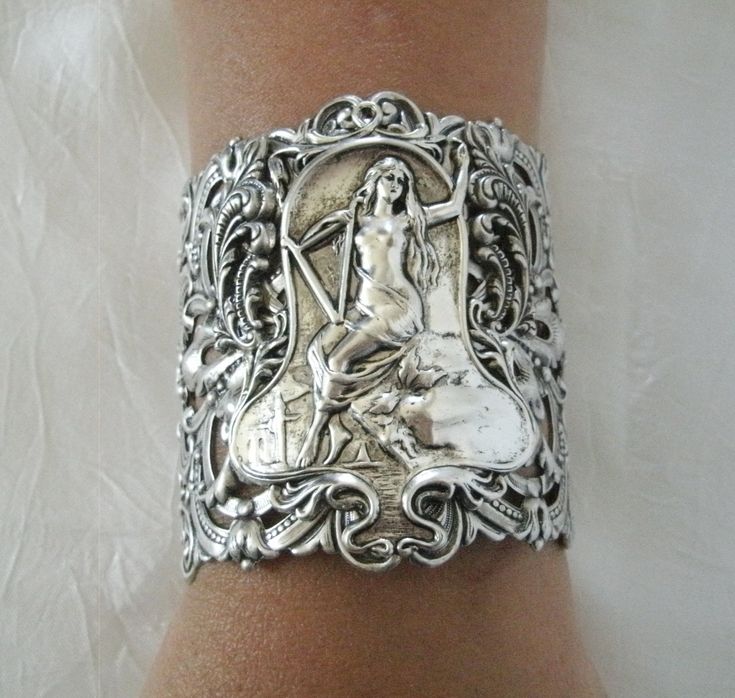 "This beautiful bracelet has a silver plated filigree cuff, silver plated chain, silver plated goddess and silver plated leaf accents. 3\" wide. Silver plated lobster clasp. 7\" long adjustable to 9\" long." Spiritual Sterling Silver Cuff Bracelet For Weddings, Bohemian Hand Cast Cuff Bracelet As A Gift, Bohemian Silver Hand Cast Bracelets, Bohemian Hand Cast Cuff Bracelet Gift, Handmade Spiritual Silver Cuff Bracelet, Handmade Gothic Silver Bracelets, Handmade Silver Gothic Bracelets, Ornate Silver Hand Cast Jewelry, Handmade Silver Gothic Bracelet