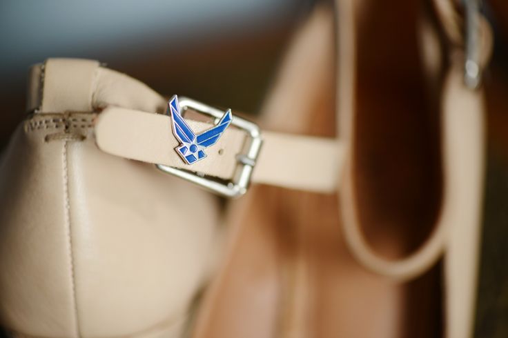 a close up of a white purse with a blue bird on the front and bottom