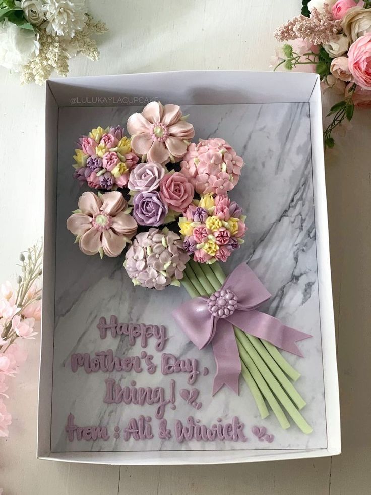 a mother's day card in a box with pink and purple flowers on it