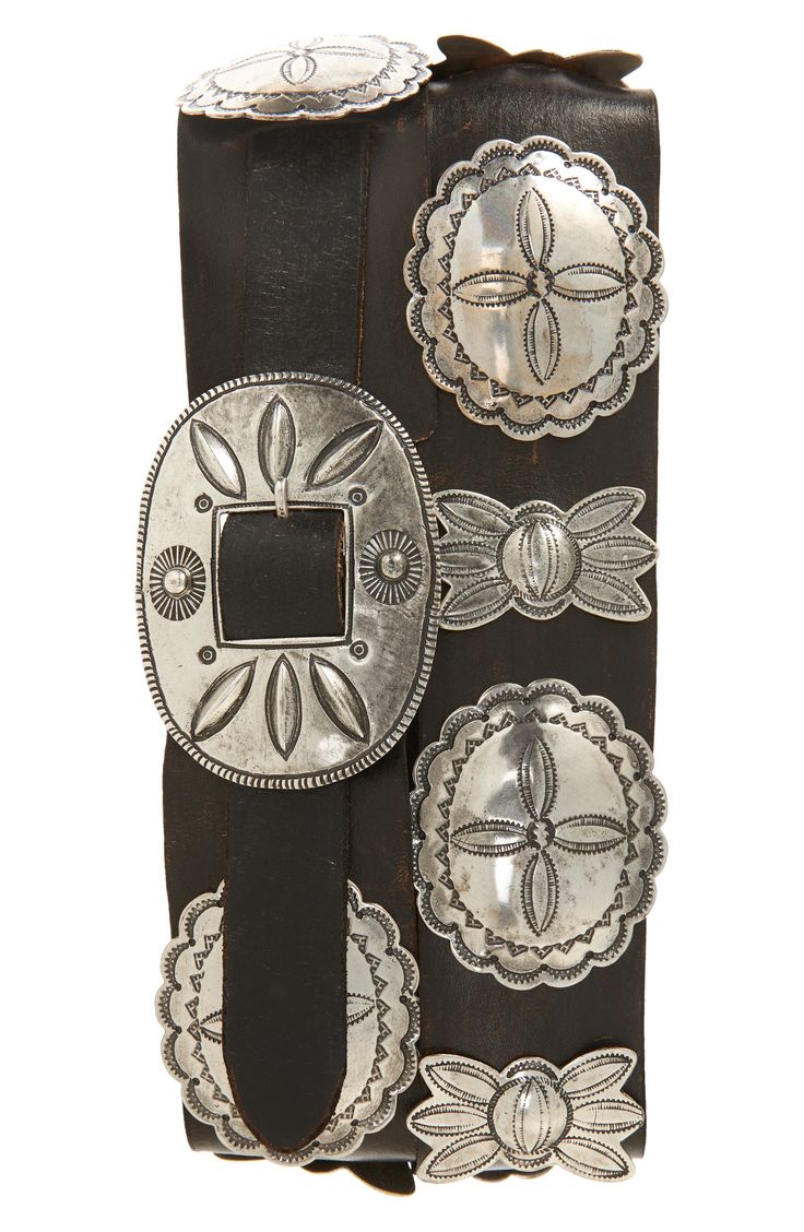 Made in collaboration with renowned Navajo silversmith Jimmy Begay, this hand-finished belt is meticulously rendered using traditional wax casting techniques. The design—reminiscent of Navajo Third Phase concho belts—features cast silver-plated brass pieces with repoussé and traditional stamped motifs, alternating between butterflies and oval conchos, and a single-prong oval-shaped buckle on a vegetable-tanned leather strap. Leather Made in the USA Black Western Belt, Concho Belts, Belt Buckles Men's, Cowboy Belt Buckles, Cowboy Belt, Western Buckles, Western Accessories, Concho Belt, Ralph Lauren Style