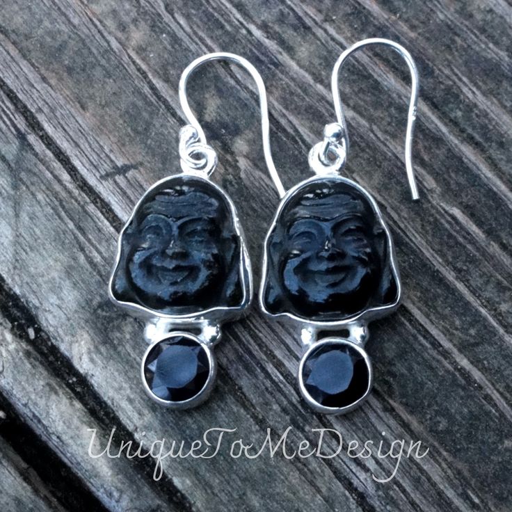 "Handmade Carved Buddha Obsidian and Black Onyx gemstone sterling silver earrings 🖤Featured in this listing is a sterling silver, handmade, natural stone pair of earrings.  These lovely handmade earrings feature beautiful, hand carved Natural Obsidian Buddha face stones, with Natural Black Onyx round stones.  All hand set into .925 Sterling Silver.   Main Stone:Natural Obsidian (14x4mm) , Black Onyx (6mm) Metal:.925 Sterling Silver Dimensions of Earrings :1 1/2\" x 1/2\"  (including hook) 🌙Be Unique Black Obsidian Jewelry, Black Sterling Silver Jewelry Stamped 925, Black Sterling Silver Jewelry With Matching Earrings, Black Spiritual Earrings For Gift, Spiritual Black Earrings For Gift, Handmade Black Sterling Silver Jewelry, Black Natural Stone Dangle Earrings, Black Earrings With Natural Stones, Onyx Gemstone Earrings For Gifts