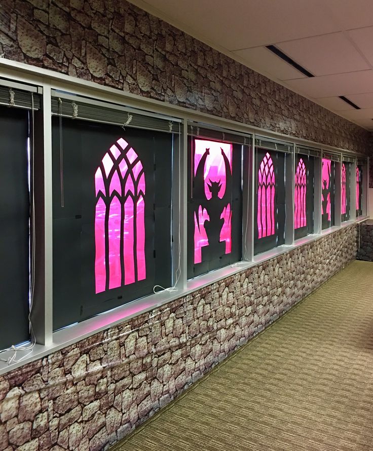 the windows are decorated with pink and black designs on brick walls, along with carpeted flooring